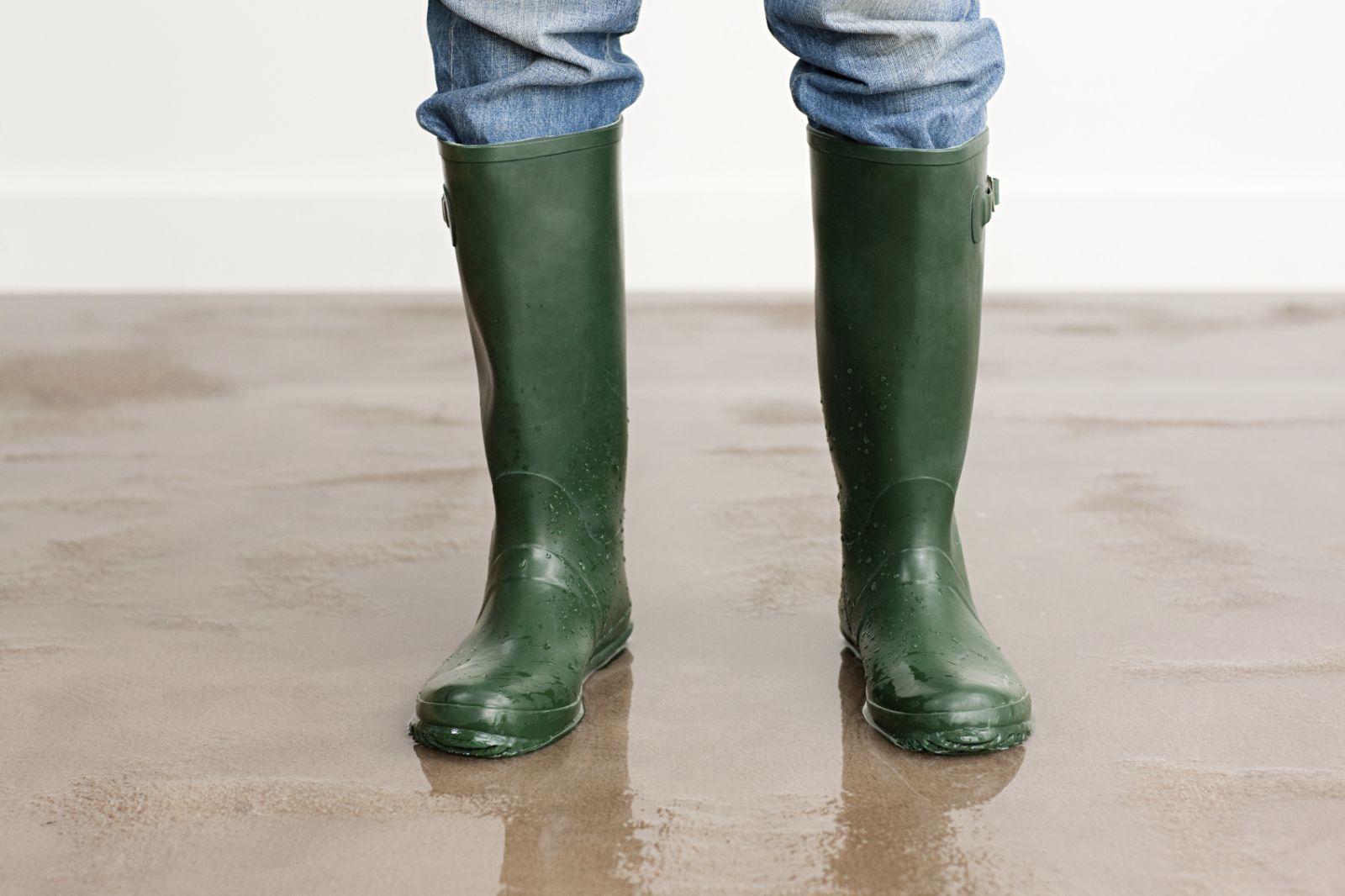 Green boots standing in water
