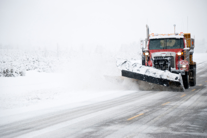 Photo of a snow plow on a winter road